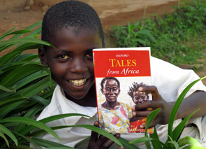 boy with tales from africa book, pelican post, charitable organization, ngo, landmark forum graduates making a difference